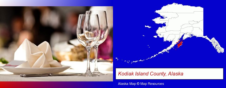 a restaurant table place setting; Kodiak Island County, Alaska highlighted in red on a map